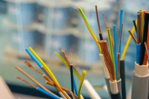 A vibrant close-up showcases colorful electrical wires, their copper strands gleaming in sharp focus.