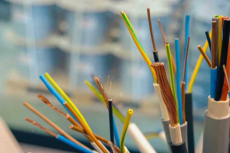 A vibrant close-up showcases colorful electrical wires, their copper strands gleaming in sharp focus.