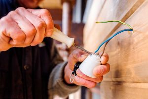 Electrician Connects Wires With Screwdriver